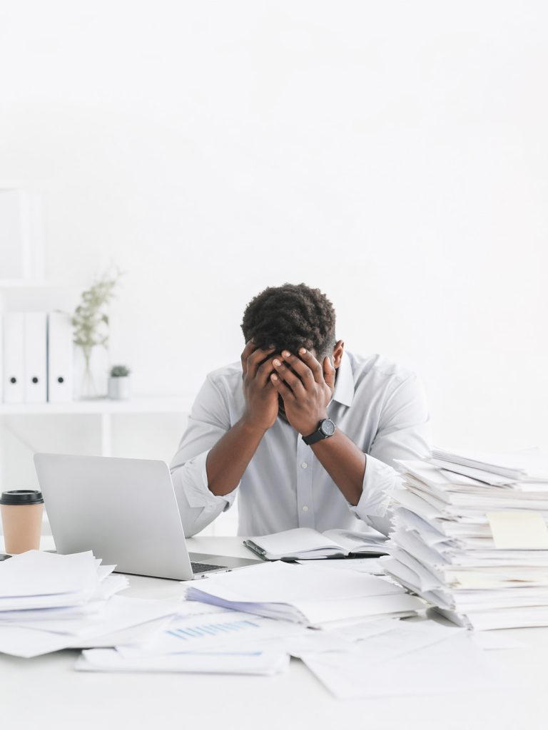 Overwhelmed staff member at office desk